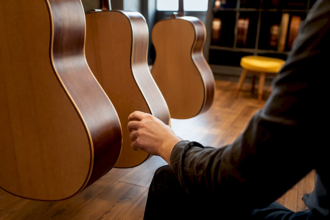 Three acoustic guitar body sizes in shop