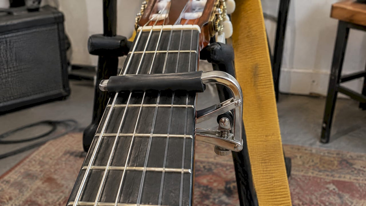 Classical guitar fitted with a capo