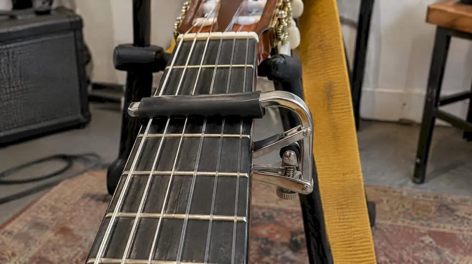 Classical guitar fitted with a capo