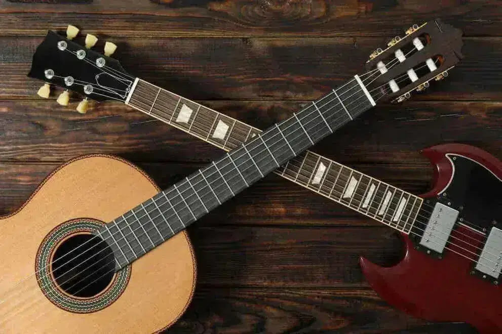 Electric vs Acoustic Guitar, Which Should You Buy as a Beginner? Image of an acoustic and electric guitar on a wooden background.
