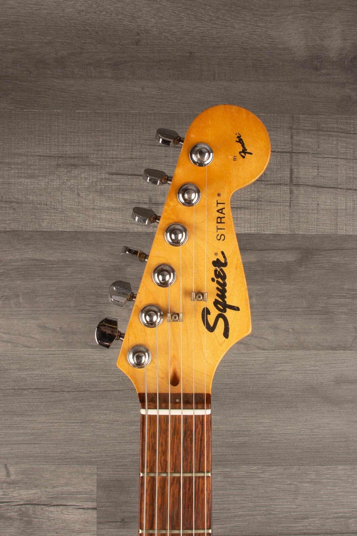 USED - Squier Stratocaster s/b guitar headstock featuring a rosewood board and maple neck.