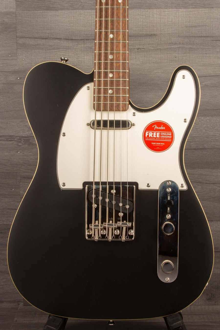 Squier Classic Vibe Baritone Custom Telecaster in satin black with parchment pickguard and Laurel fingerboard.