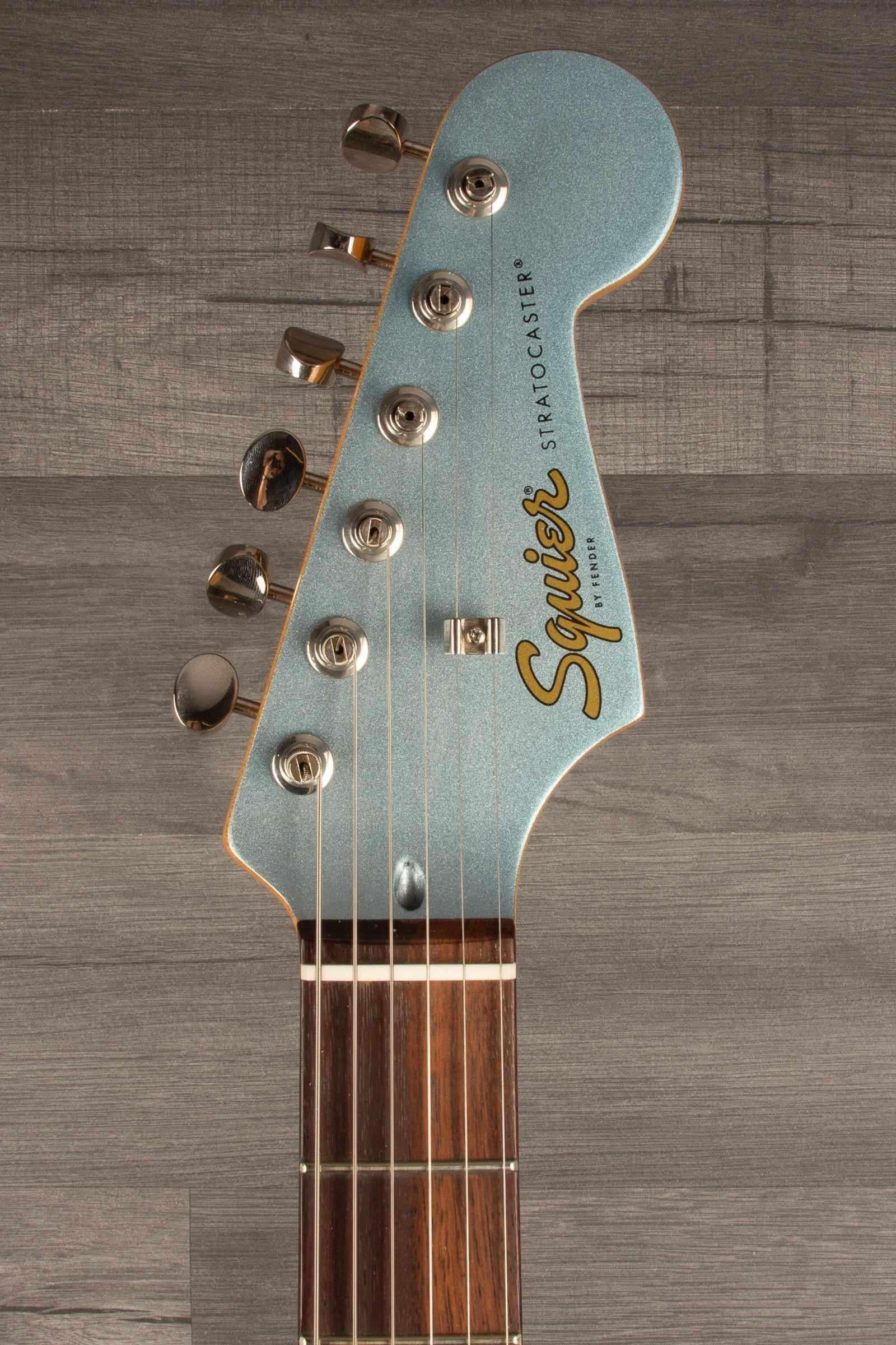 Close-up of Squier FSR Classic Vibe™ 60s Stratocaster® guitar neck and headstock in Ice Blue Metallic.