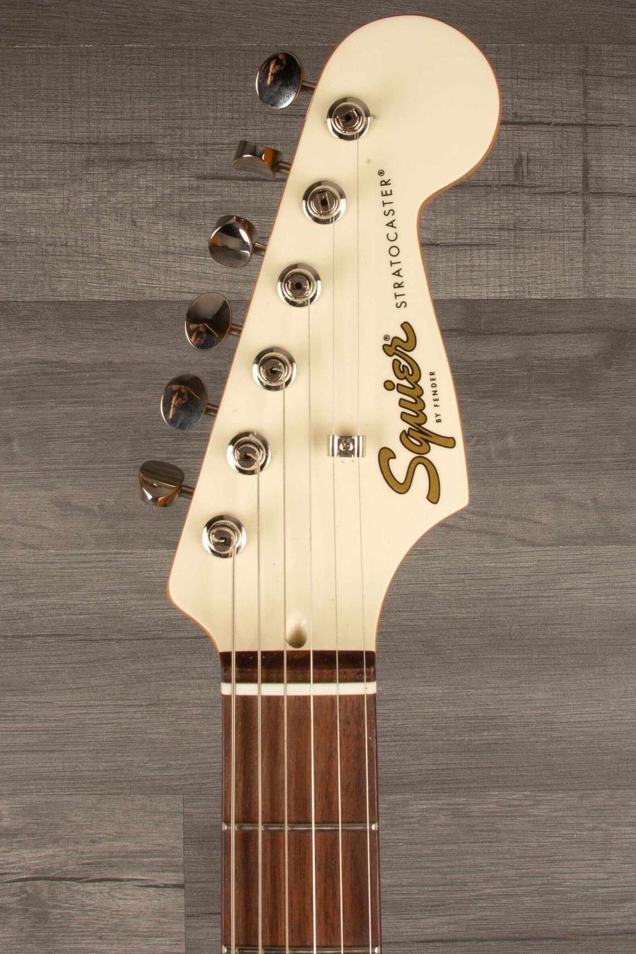 Squier FSR Classic Vibe '60s Stratocaster headstock close-up showcasing tuning pegs and logo.