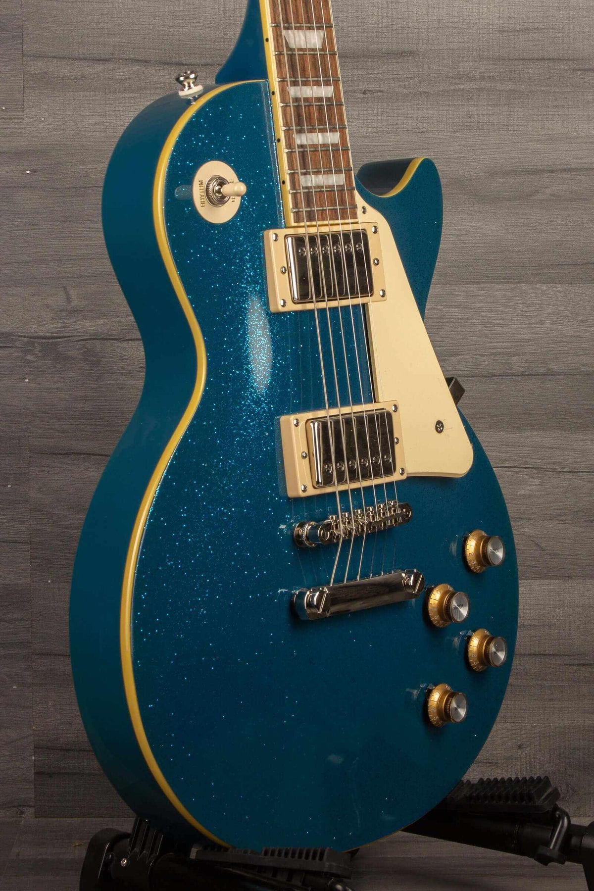Epiphone Les Paul Standard 60's Brunswick Blue Sparkle electric guitar side view showcasing its unique blue sparkle finish.