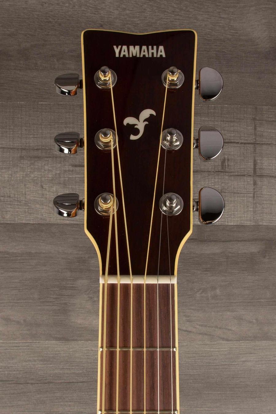 Yamaha FG840 Acoustic Guitar - Natural headstock with tuning pegs and logo on a wooden background.
