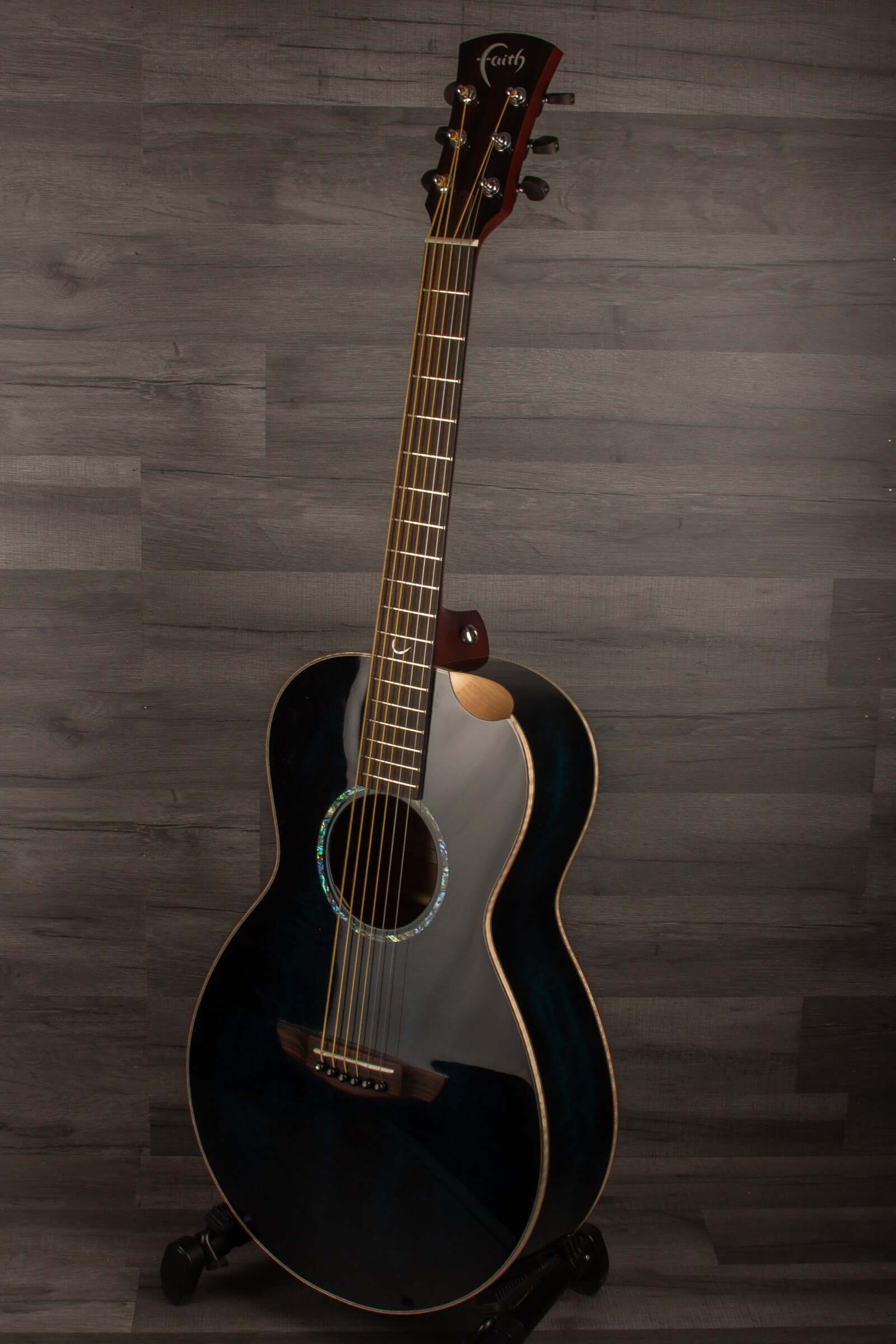 Faith BLUE MOON Series Mercury E Scoop Inc Case displayed on a stand, showcasing its unique blue wood finish.