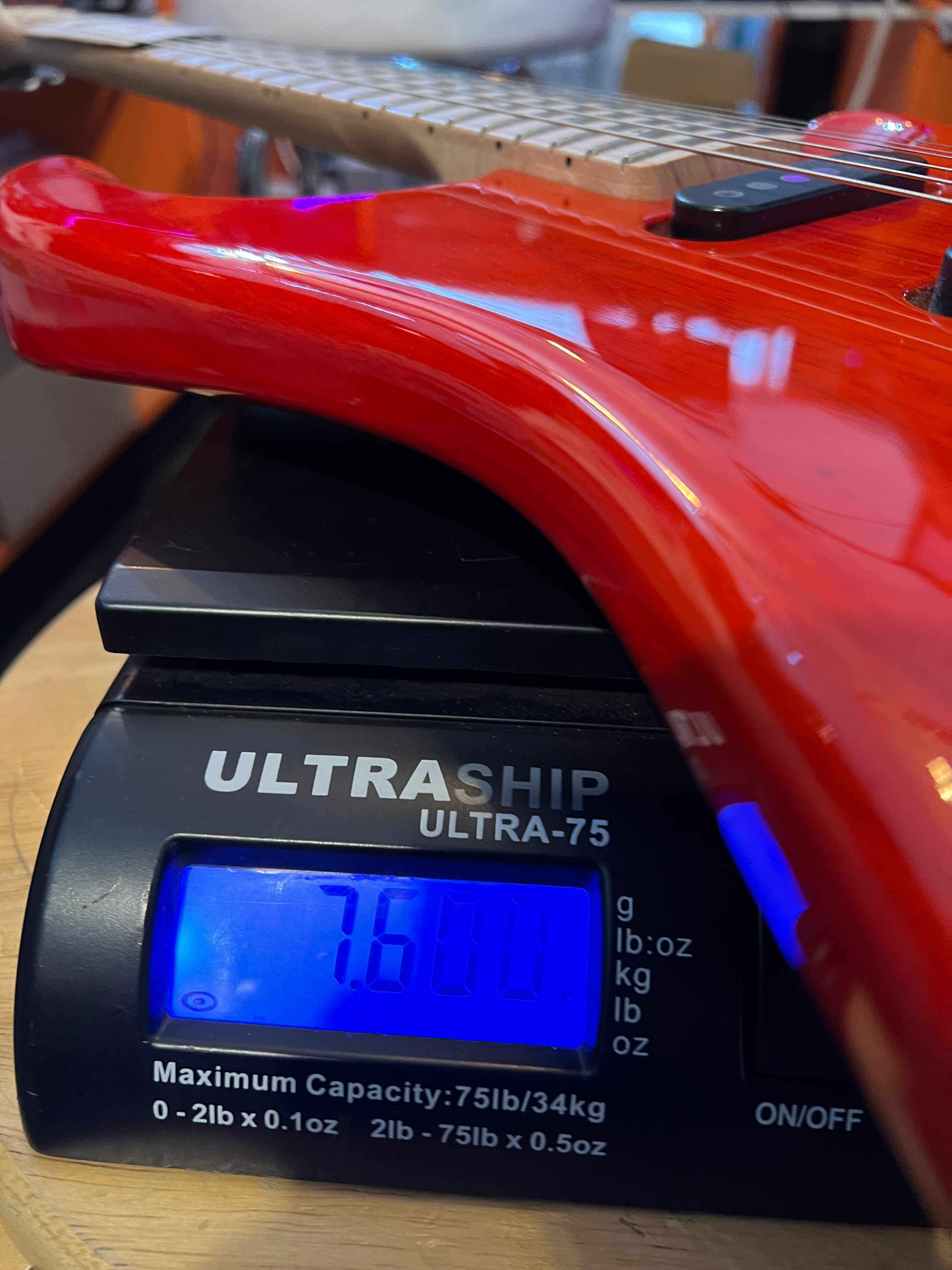 USED - PRS Mark Lettieri Signature Fiore Amaryllis weight displayed on scale, showcasing its superb condition.