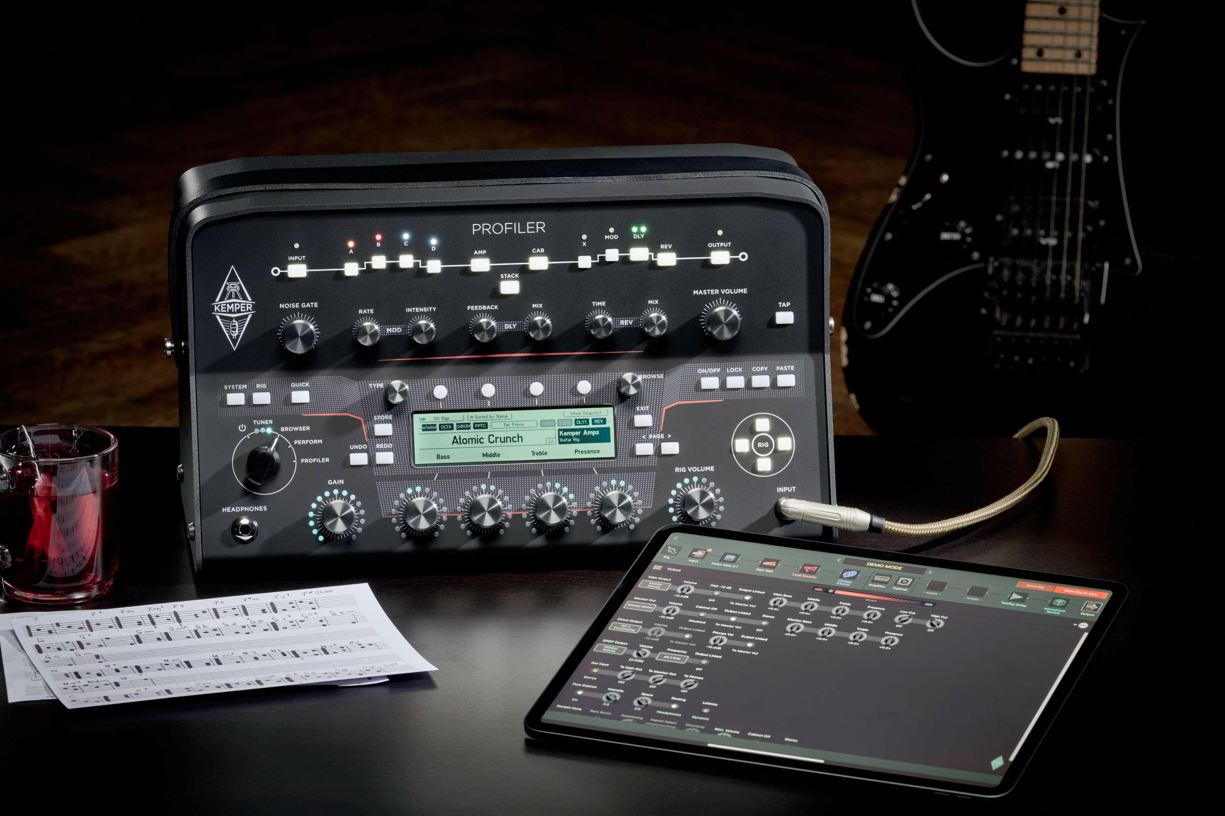 Kemper PROFILER PowerHead MK 2 with tablet and sheet music, showcasing its recording and multitracking capabilities.
