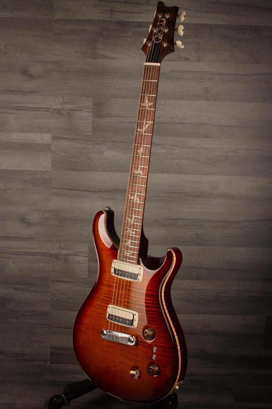 USED - PRS Paul's Guitar Dark Cherry Sunburst showcasing its unique design and craftsmanship in a studio setting.