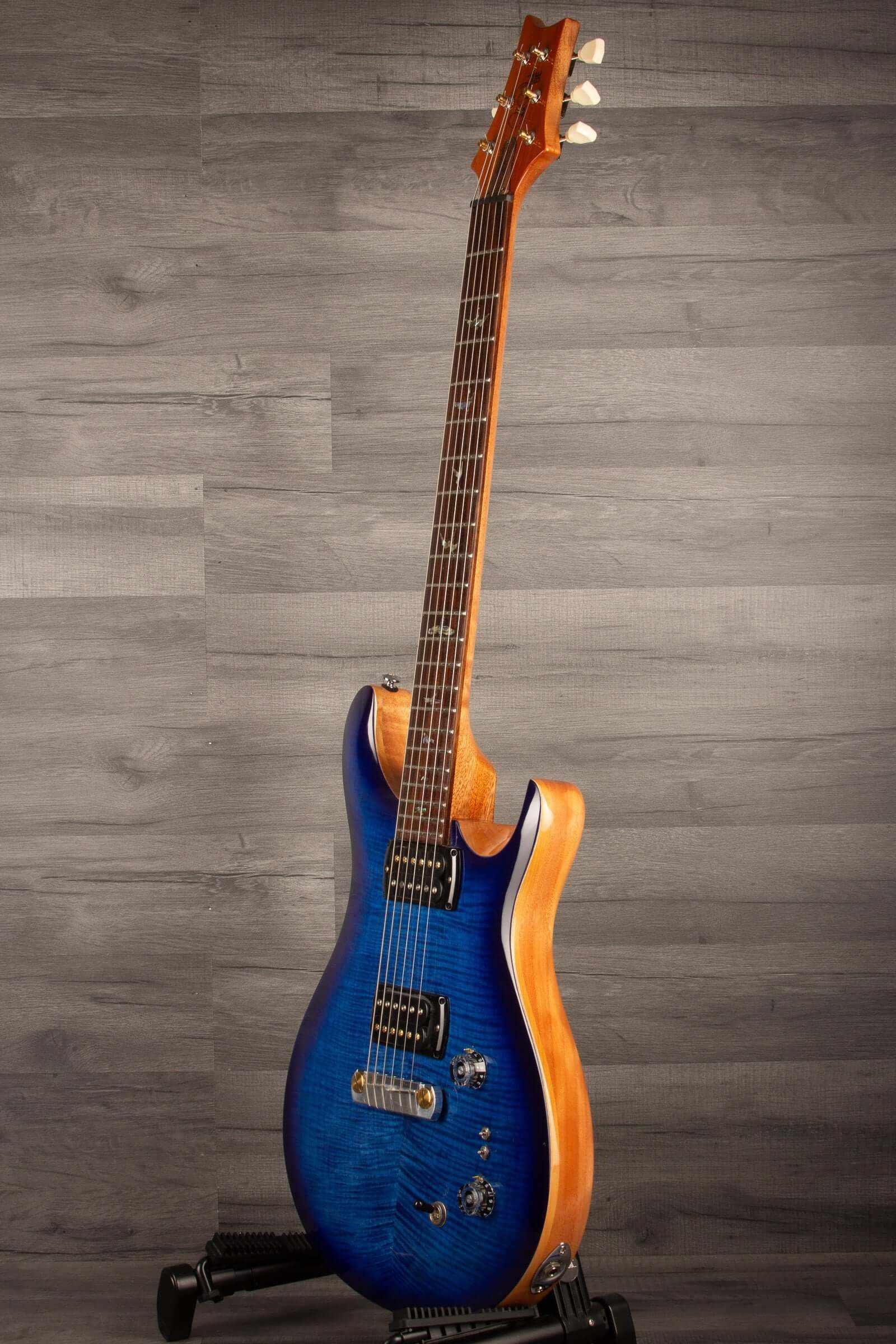 USED - PRS SE Paul’s Guitar Electric Guitar - Faded Blue Burst on display with gig bag.