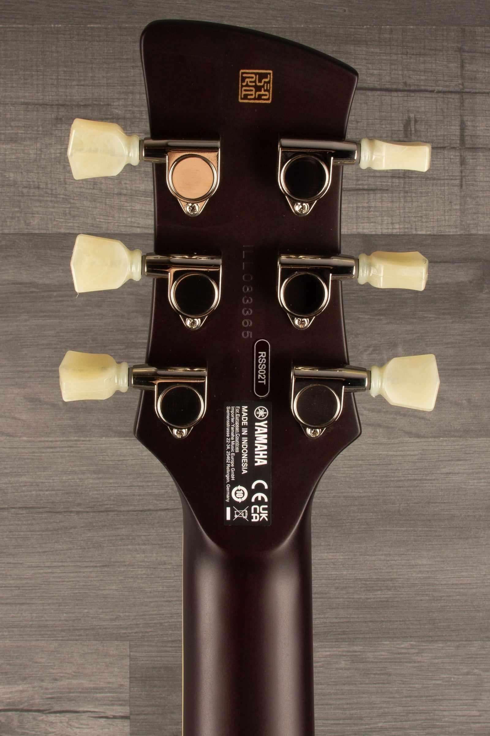 Yamaha RSS02T Revstar - Fire Red guitar headstock featuring tuning pegs and brand logo.