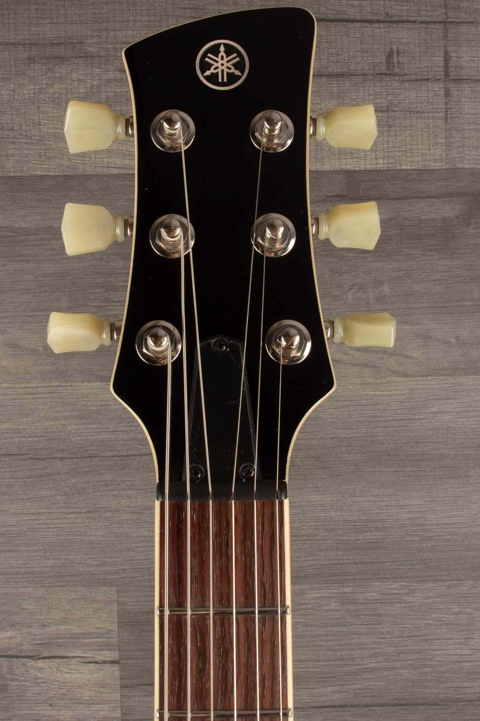 Yamaha RSS02T Revstar - Vintage White guitar headstock showing tuning pegs and strings.