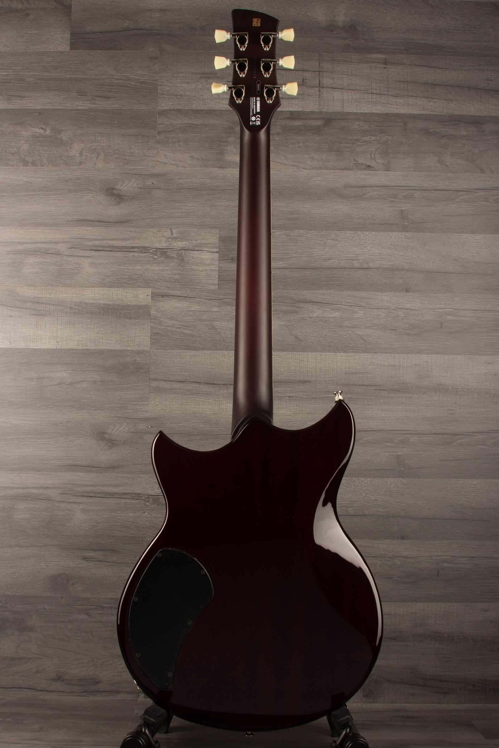 Yamaha RSS20 Revstar -Sonic Blue guitar body and neck viewed from behind on a wooden background.