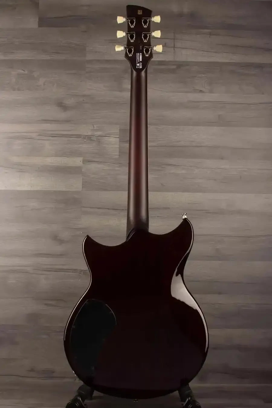 Yamaha RSS20 Revstar -Sonic Blue guitar body and neck viewed from behind on a wooden background.