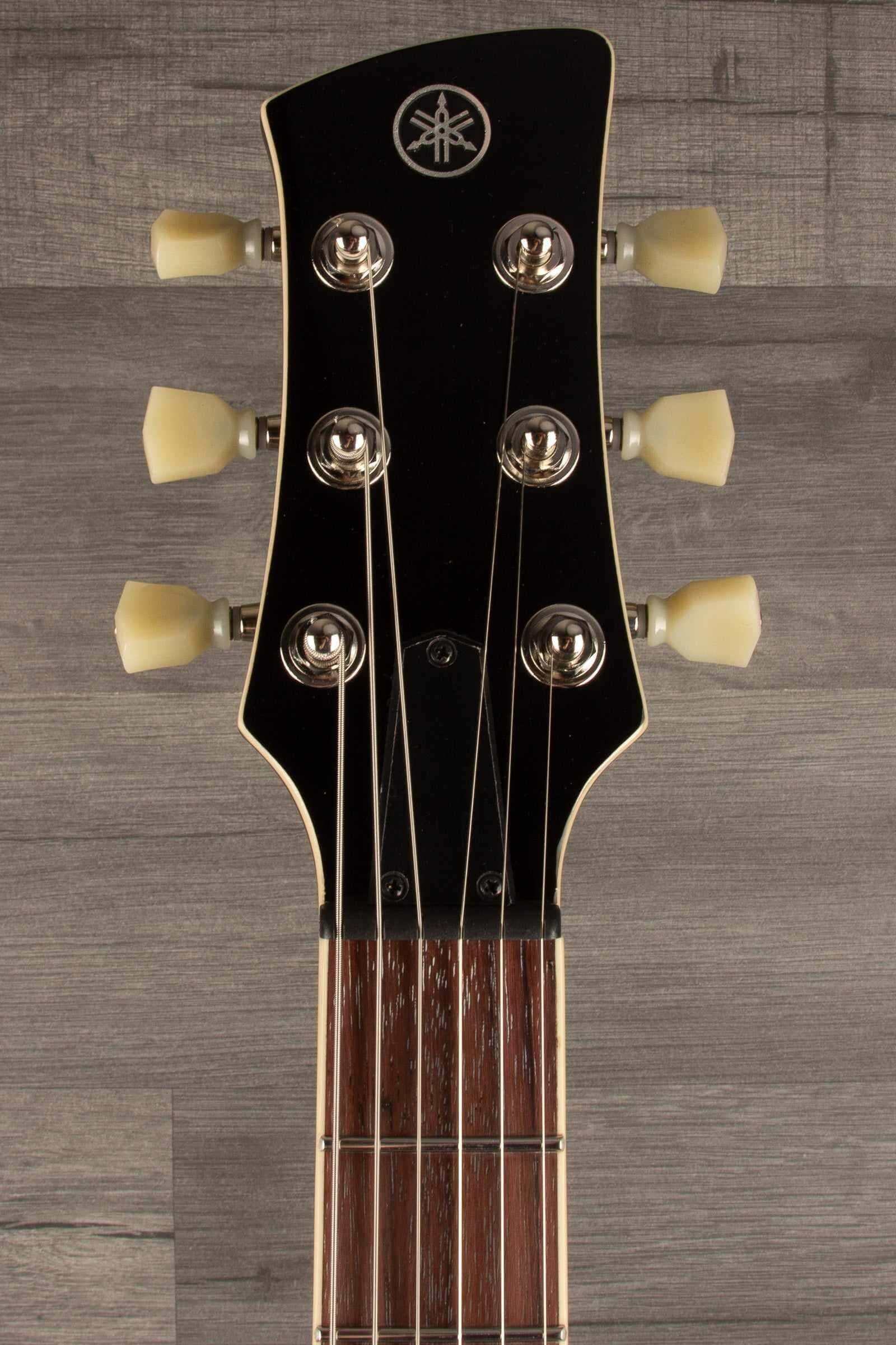 Yamaha RSS20 Revstar -Sonic Blue guitar headstock featuring tuning pegs and distinctive logo.