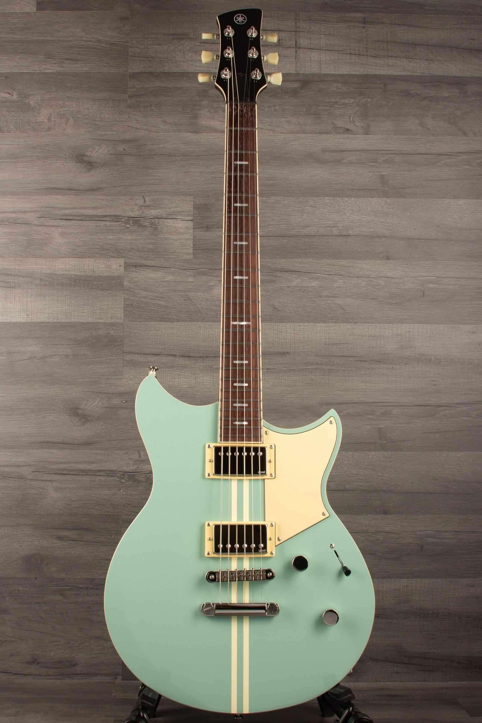 Yamaha RSS20 Revstar -Sonic Blue guitar with unique body shape and Alnico Humbuckers against a gray background.