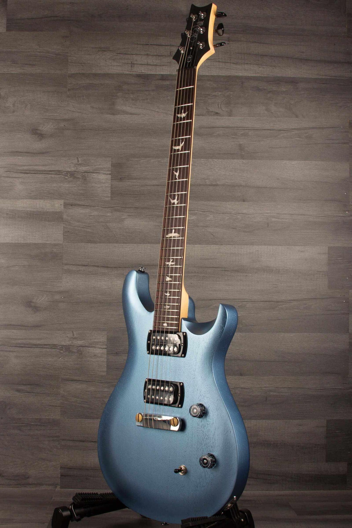 PRS SE CE24 Standard Stoptail guitar in ice blue metallic finish with a satin texture.