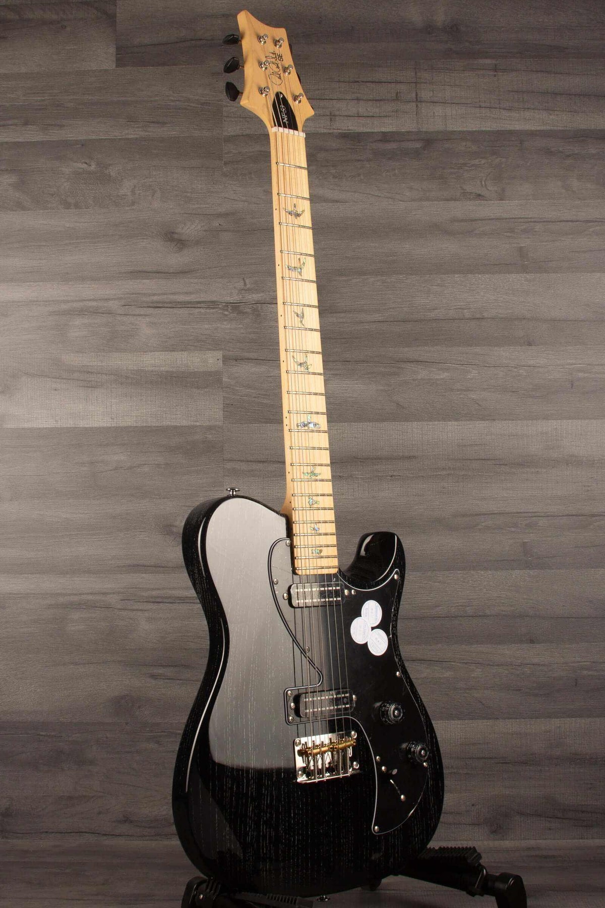PRS SE NF53 Electric Guitar, Black Doghair Finish with a distinctive design on a wooden background.