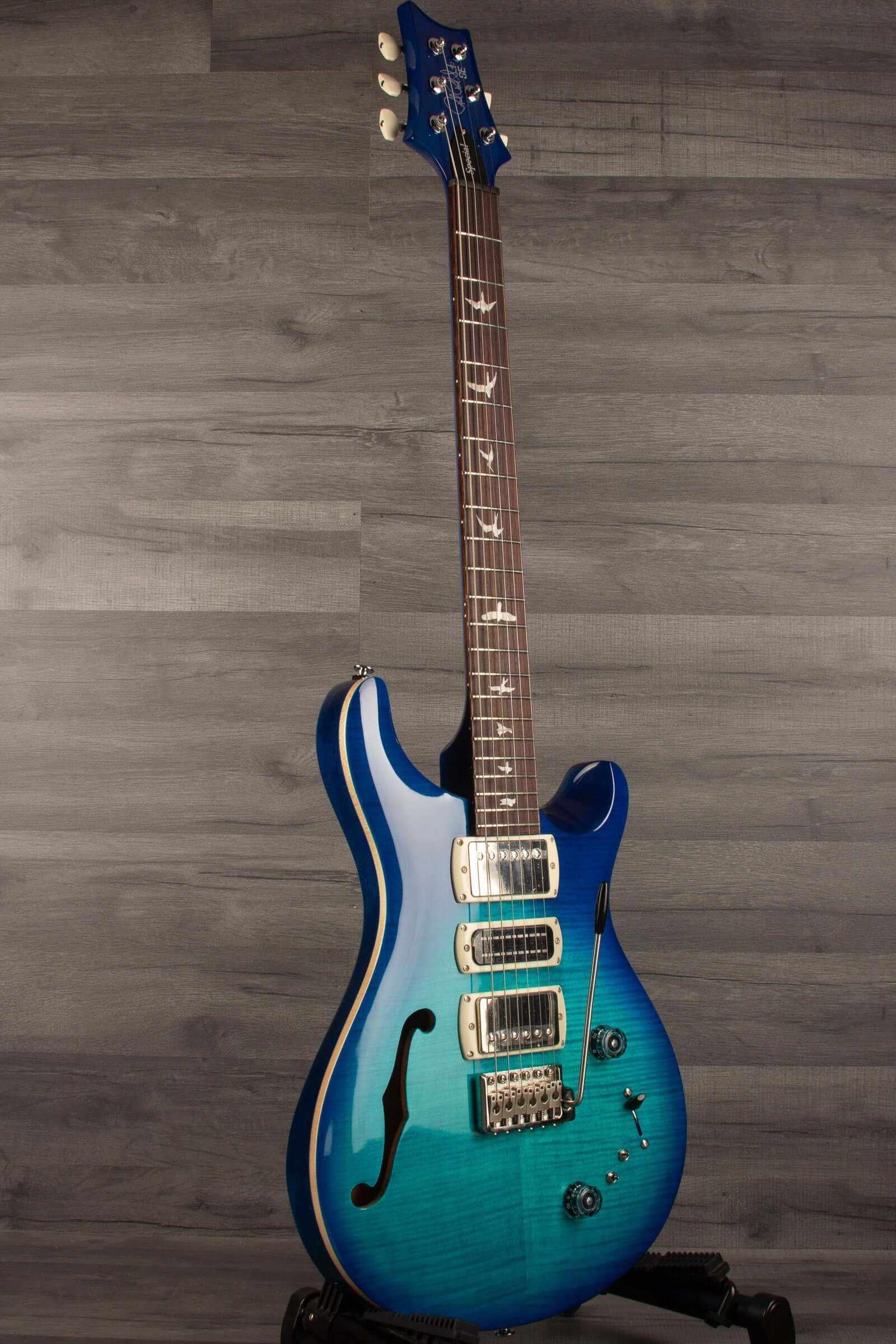 PRS SE Special Semi Hollow - Lake Blue guitar on display, showcasing its semi-hollow body and beautiful blue finish.