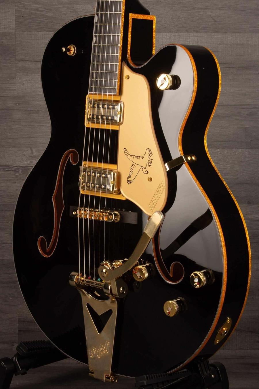 Gretsch Synchromatic™ Falcon™ Hollow Body Single-Cut with Bigsby®, Ebony Fingerboard, Black displayed on a stand.
