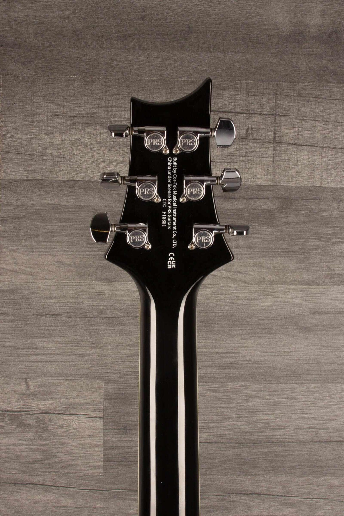 Close-up view of the PRS SE Hollowbody Standard guitar headstock with tuning pegs.