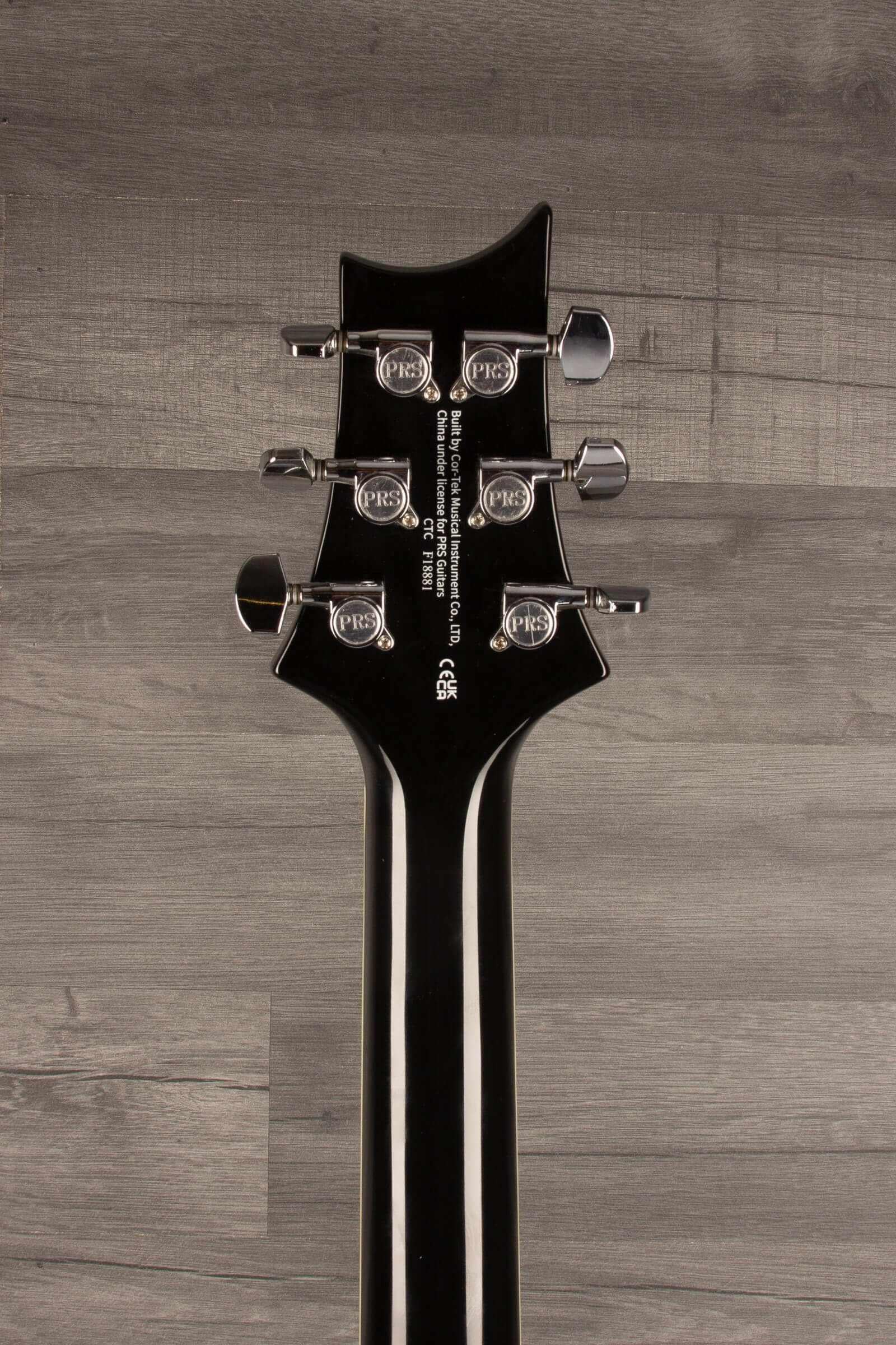 Close-up view of the PRS SE Hollowbody Standard guitar headstock with tuning pegs.