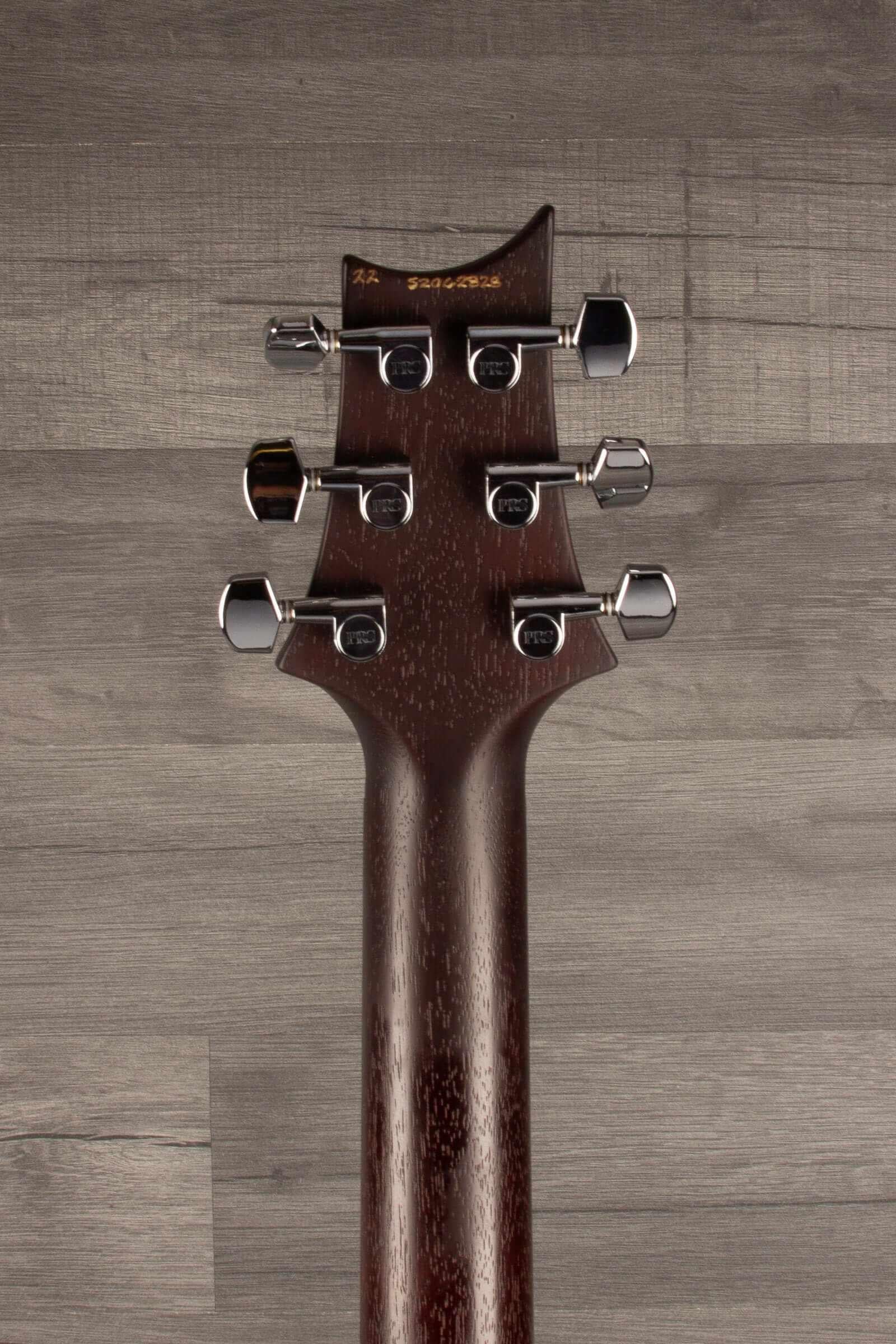 PRS S2 Standard 24 Satin guitar headstock showcasing tuners and mahogany neck detail.
