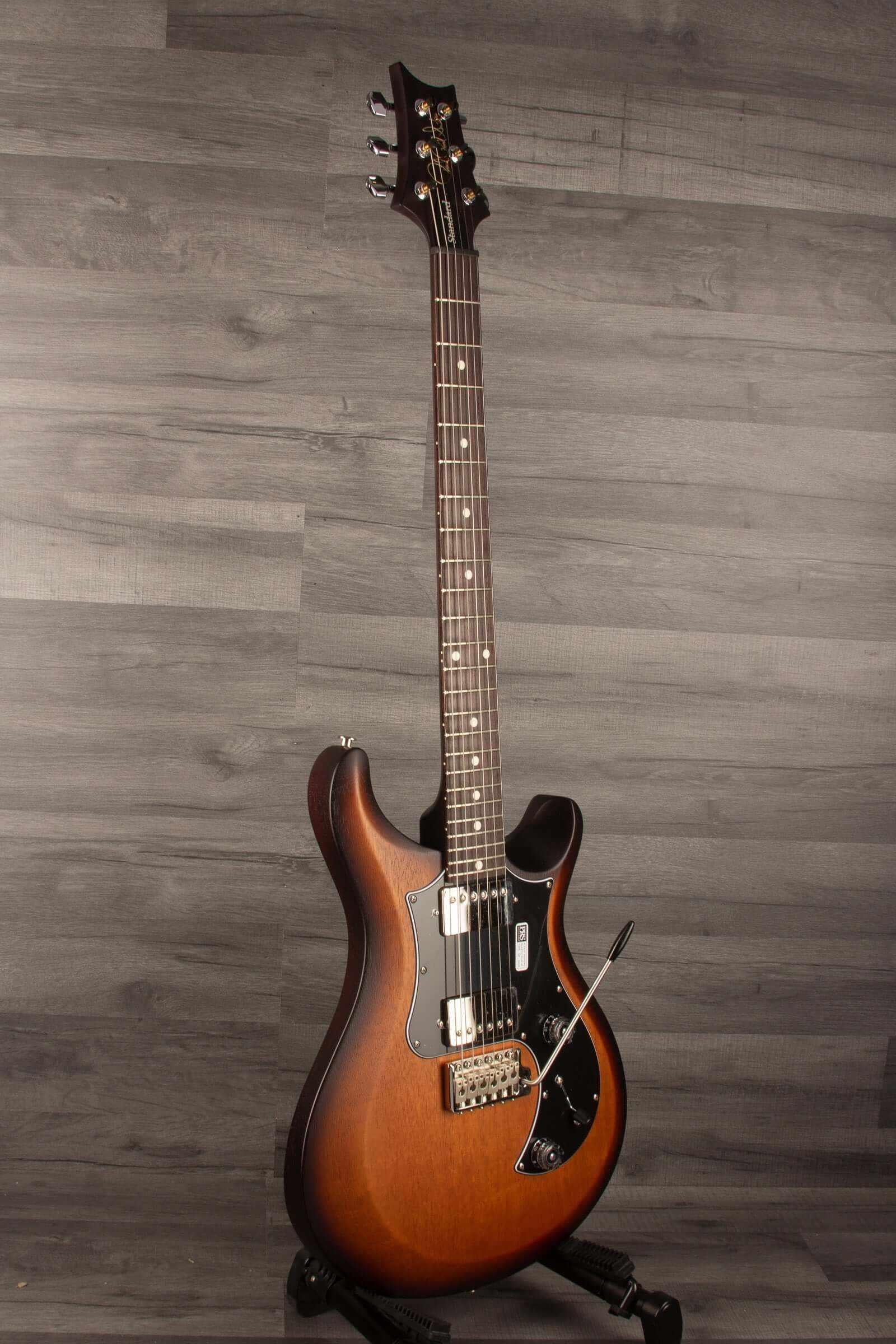 USED - PRS S2 Standard 24 Satin - McCarty tobacco sun burst guitar on display, showcasing its mahogany build and sleek design.