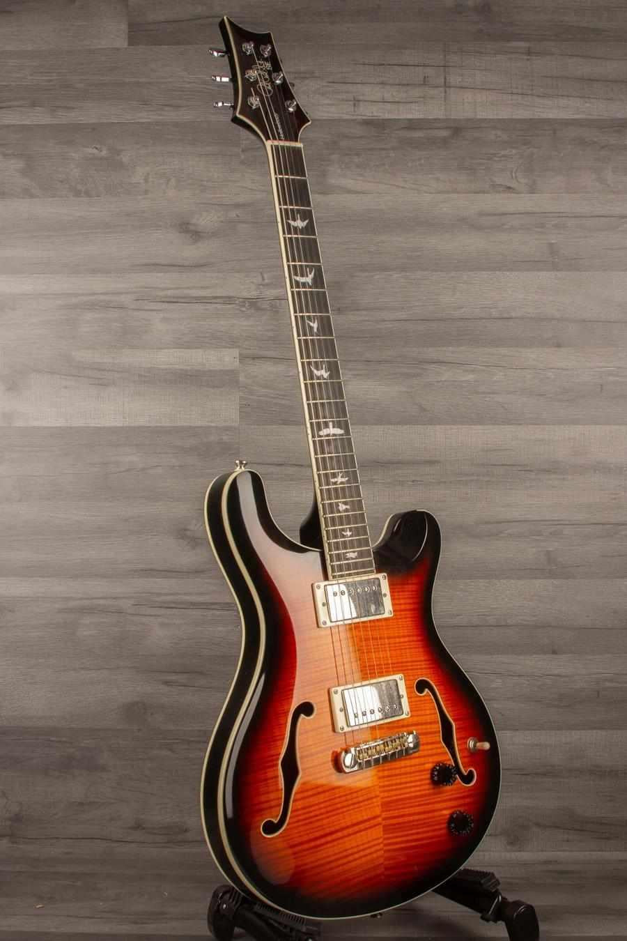 USED PRS SE Hollowbody II Electric Guitar - Tricolour Sunburst displayed on a stand against a gray background.