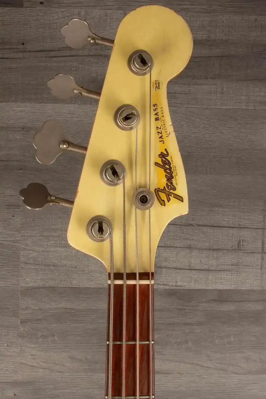USED Fender Custom shop 64 Jazz Bass headstock with tuning pegs and logo, in good condition.