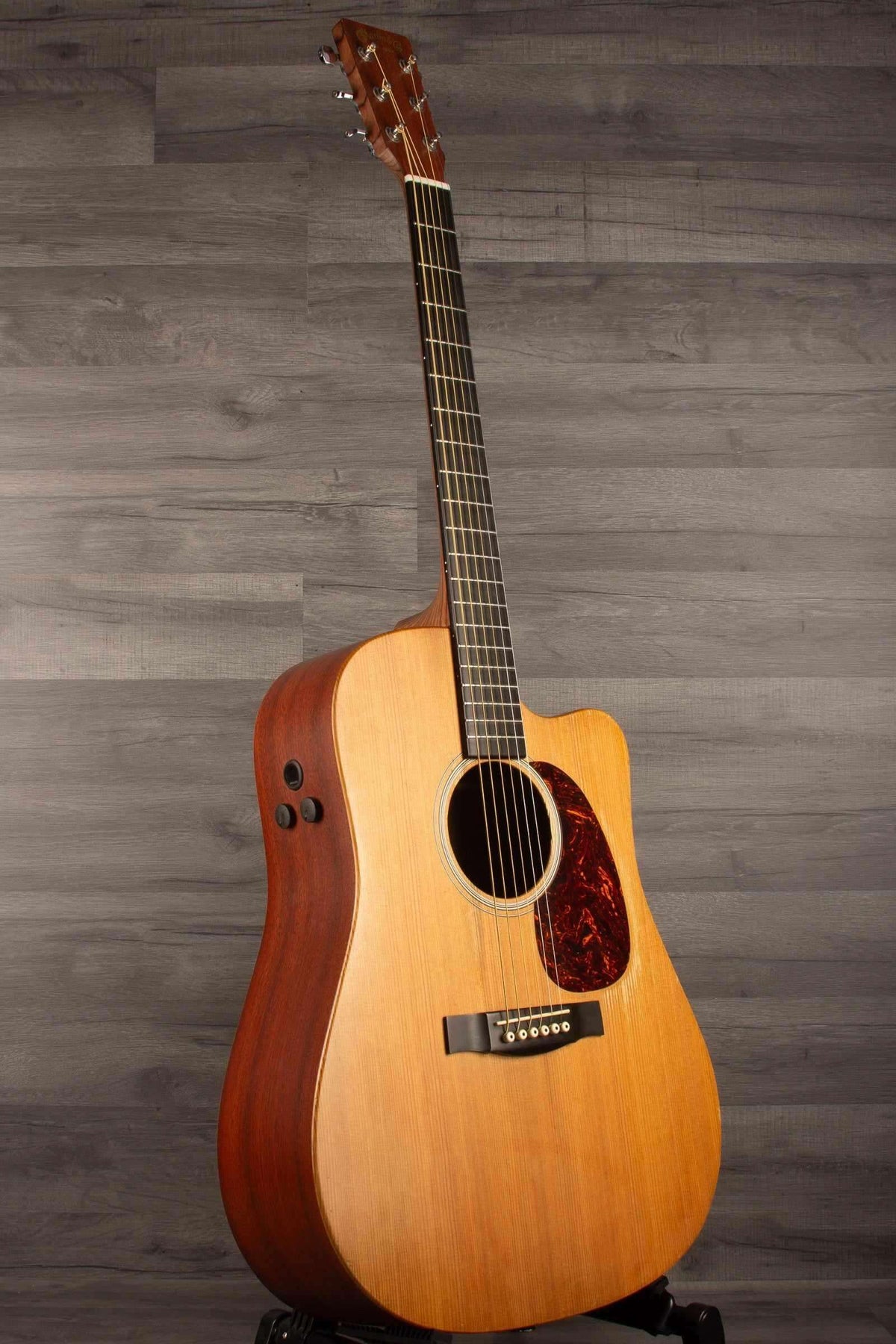 USED - Martin - DCPA5 Performing Artist Dreadnought inc hard case displayed on a pedestal against a wooden backdrop.