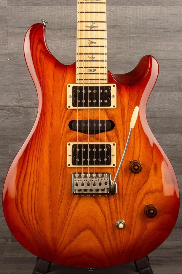 USED - PRS SE - Swamp Ash Special - Vintage Sunburst guitar showcasing beautiful wood grain and upgraded hardware.