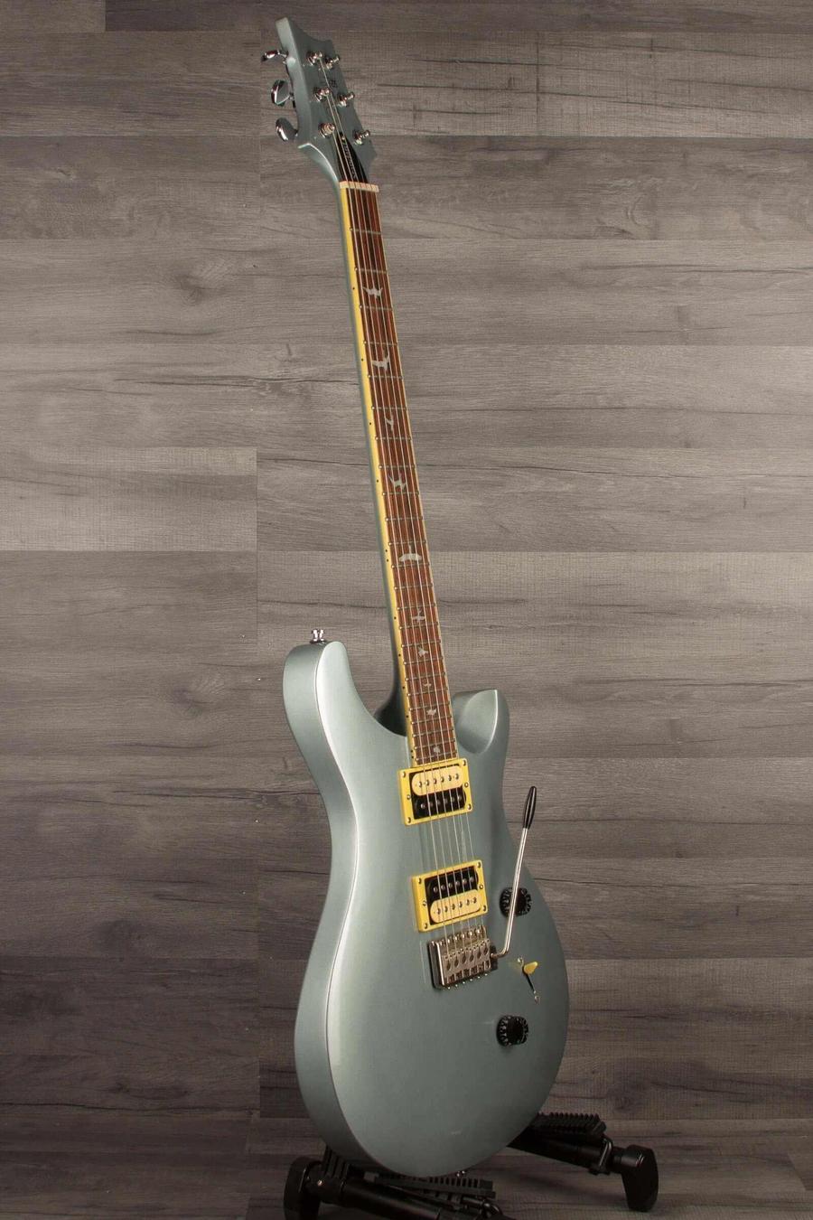 USED - PRS SE Standard 24 Electric Guitar - Bay Bridge Blue displayed on a stand against a wooden background.
