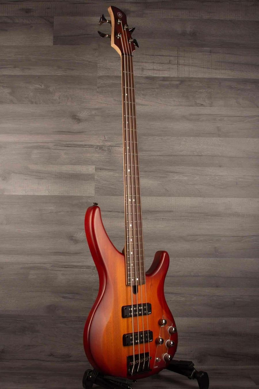 Yamaha TRBX504 Brick Burst Bass Guitar showcasing a mahogany body in a slick Translucent Brown finish