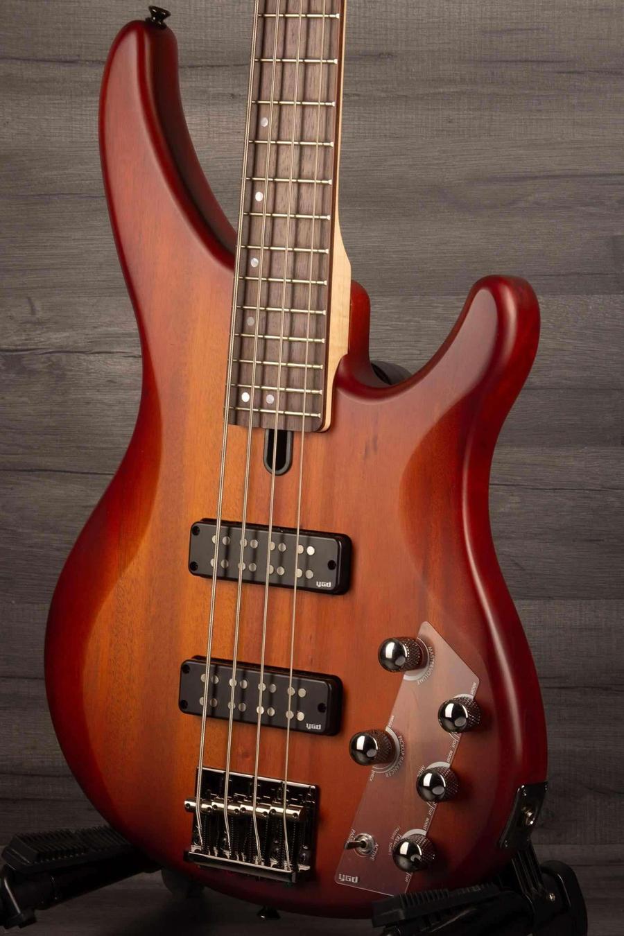 Yamaha TRBX504 Brick Burst Bass Guitar showcasing the mahogany body and sleek design in Translucent Brown finish.