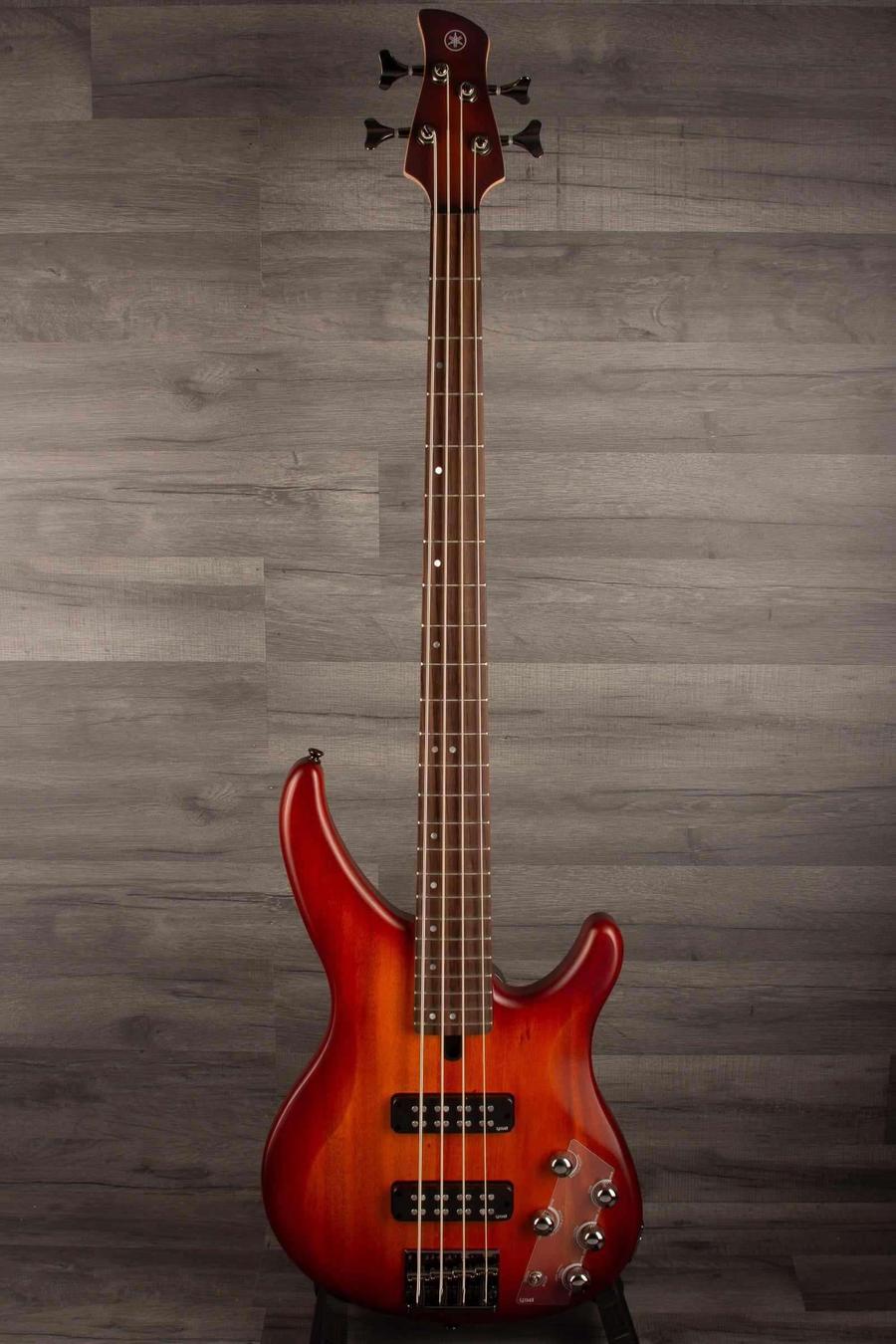 Yamaha TRBX504 Brick Burst Bass Guitar showcasing its slick Translucent Brown finish and dynamic design.