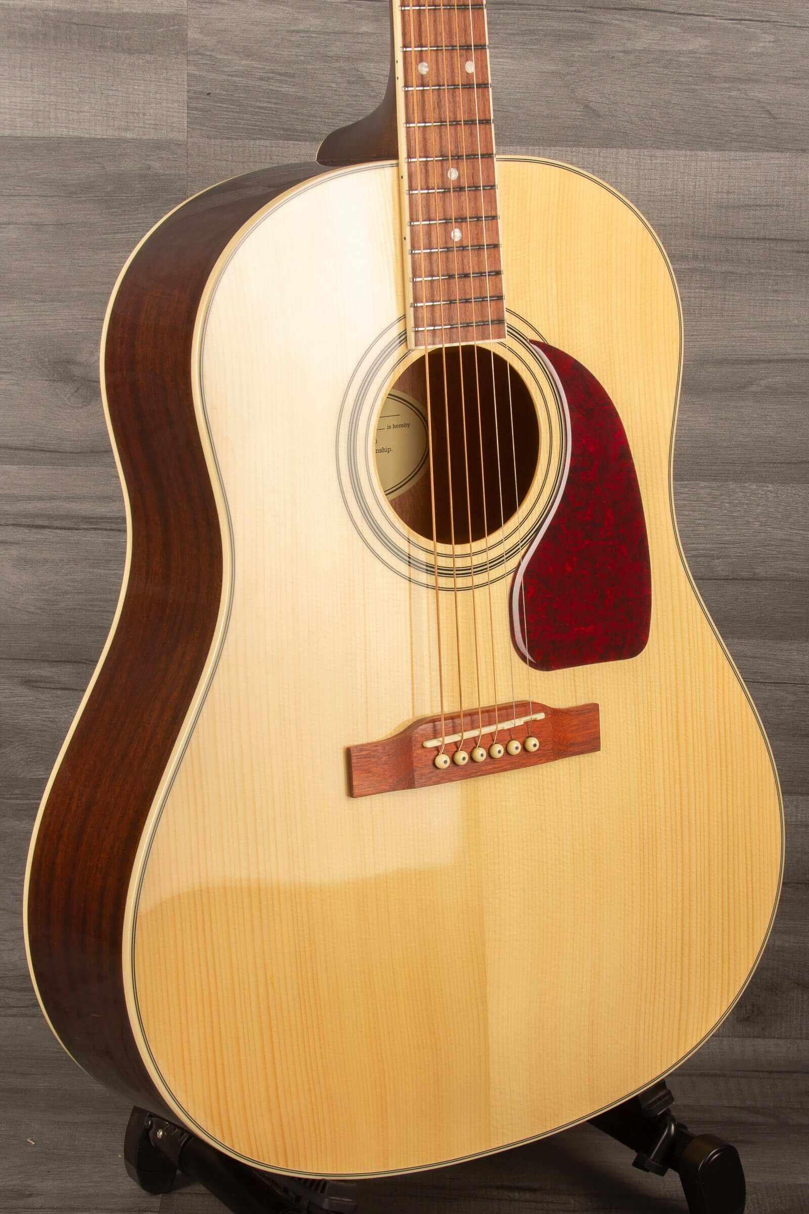 Epiphone J45 Studio Solid Top - Natural, Acoustic Guitar displayed at an angle, showcasing its quality construction and design.