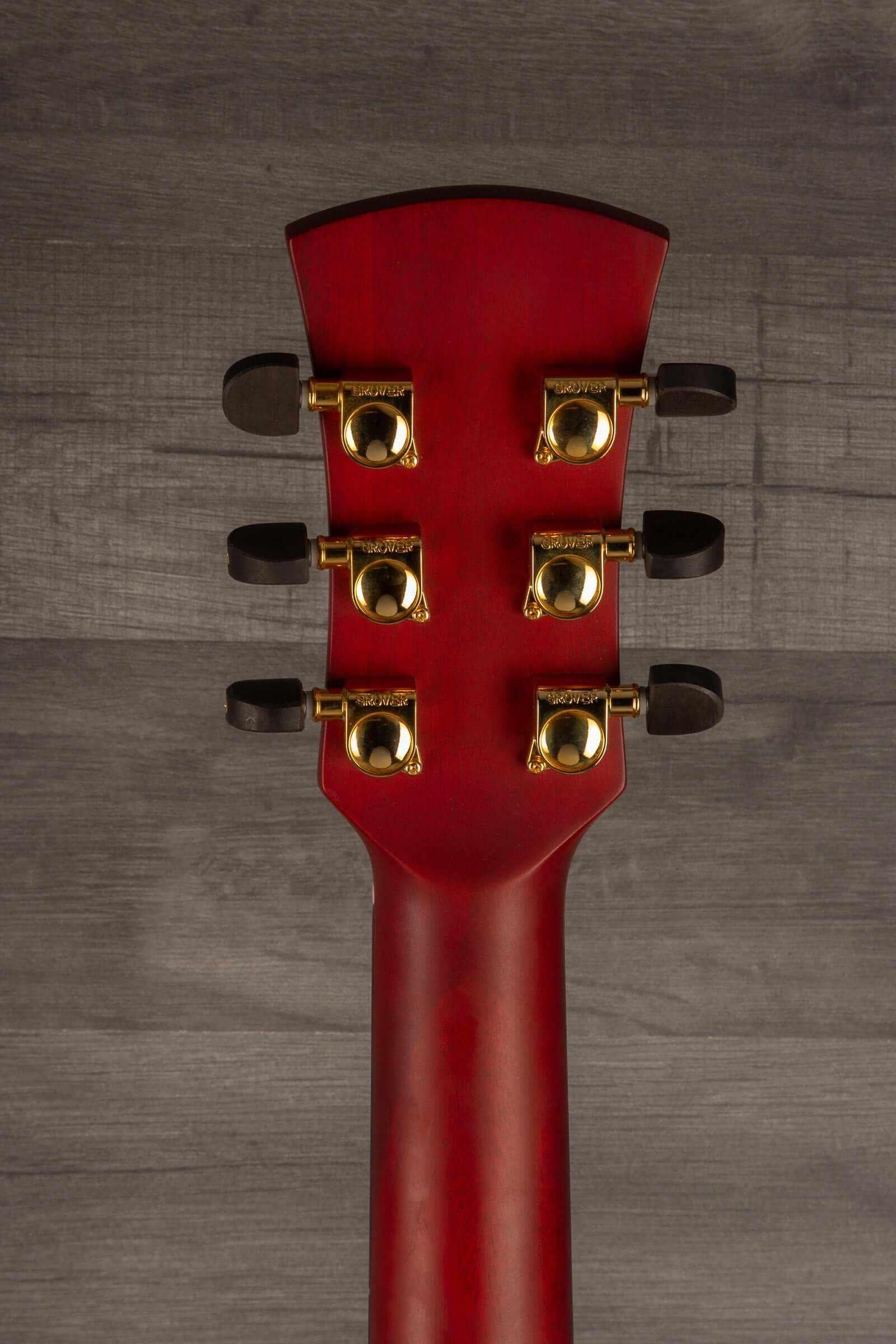 Faith BLOOD MOON Series Venus CE LH Inc Case guitar headstock with gold tuning pegs against a wooden backdrop.