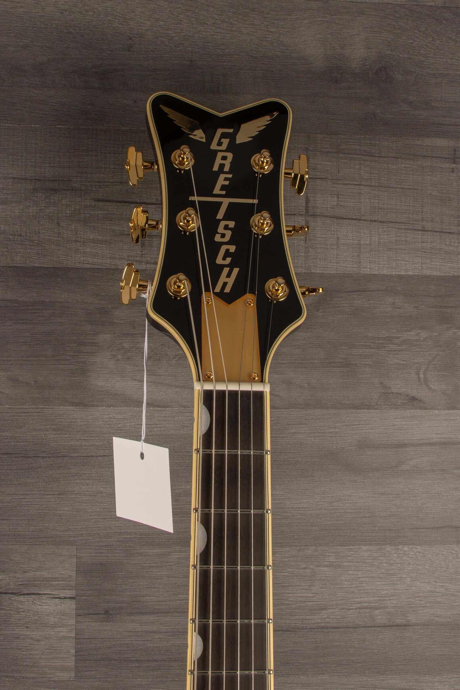 Gretsch G6134TG Limited Edition Paisley Penguin™ guitar headstock with gold tuners and tag.