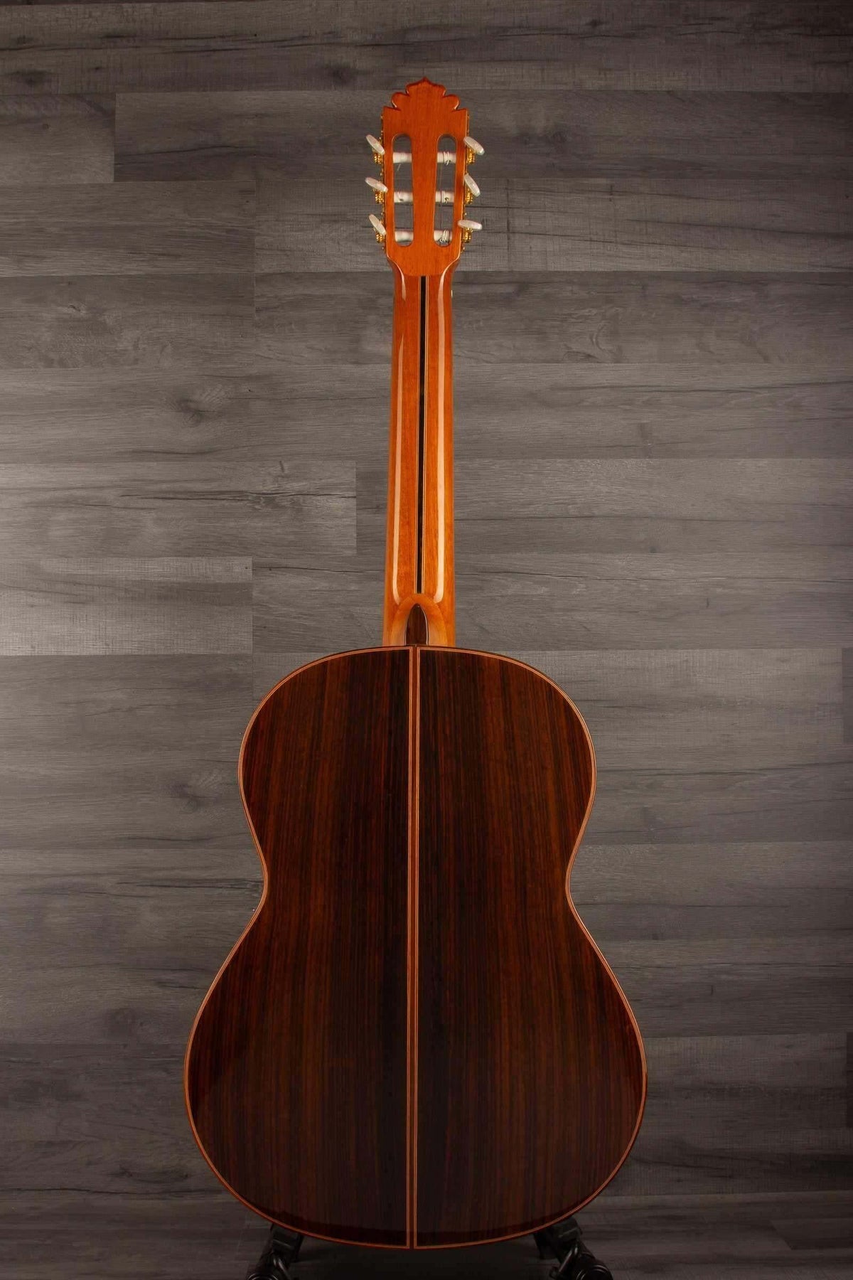 USED - Manuel Rodriguez model E guitar back view showcasing rich wood grain and craftsmanship.