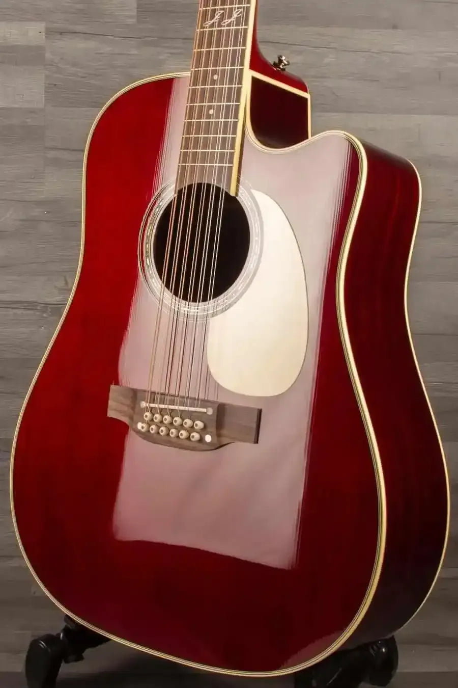 Takamine JJ325SRCL-12 John Jorgenson 12 string acoustic guitar with a glossy red finish.