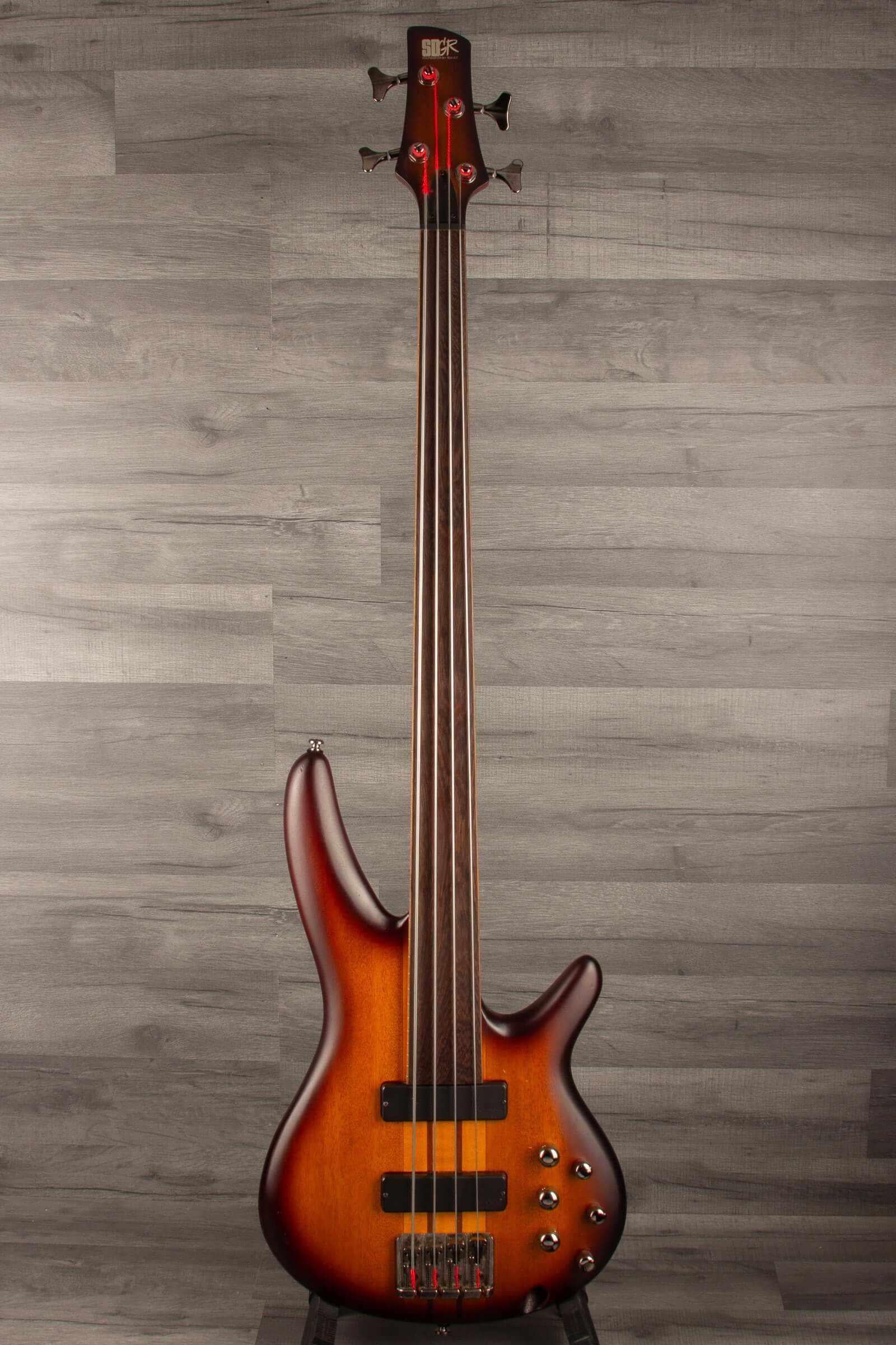 USED - Ibanez SRF700 BBF SR fretless bass - Brown burst flat on display against a wood-like background.