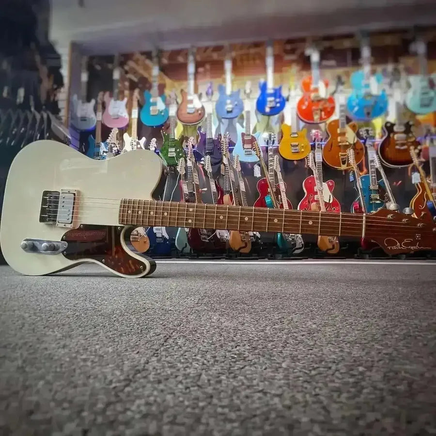 Guitar in a guitar shop showcasing vibrant selection of colorful guitars for inspiration.
