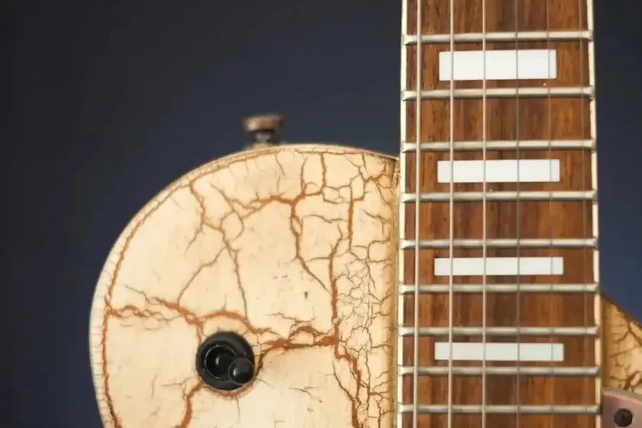 Hands tuning guitar strings close-up
