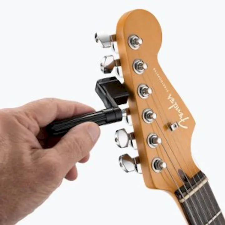 Hands changing guitar strings close-up