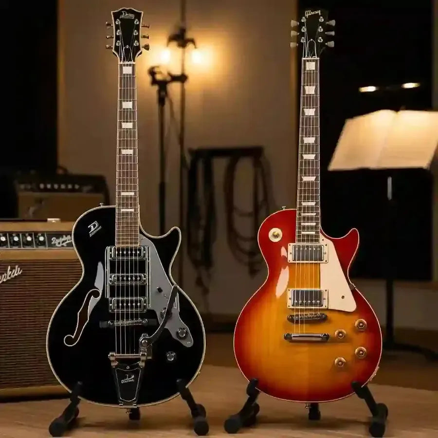 Duesenberg Starplayer TV and Gibson Les Paul electric guitars displayed in a music studio, emphasizing premium craftsmanship