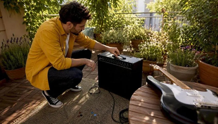 Guitarist adjusting Boss Katana amp settings