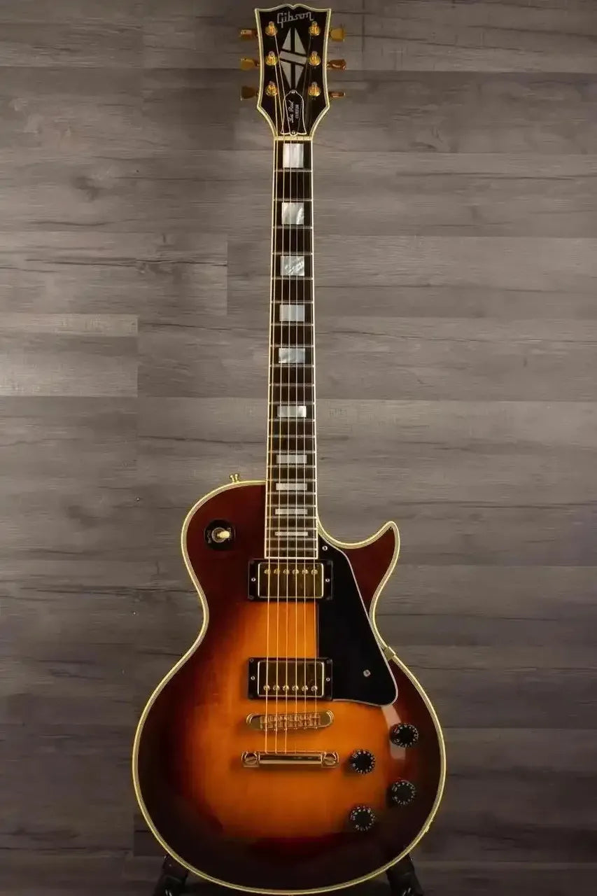 USED - Gibson 1982 Les Paul Custom - Antique sunburst beautifully showcased on a wooden background.