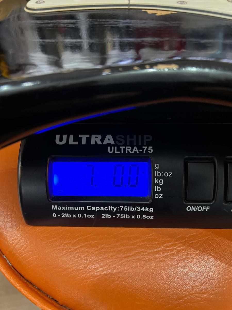 7.00 pounds displayed on ULTRASHIP ULTRA-75 digital scale in orange leather background.